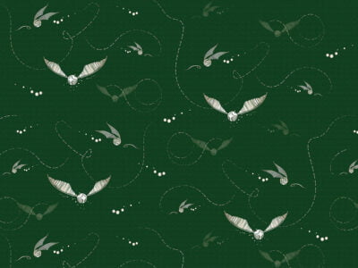 Designer wallpaper with pattern of white Harry Potter snitches on the green background