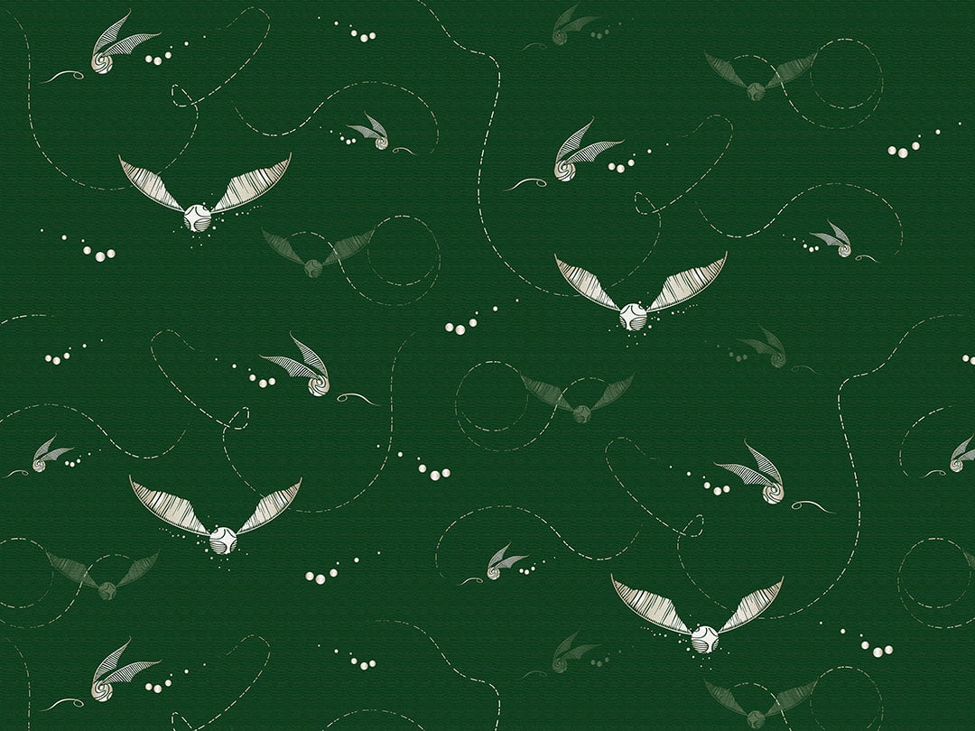 Designer wallpaper with pattern of white Harry Potter snitches on the green background