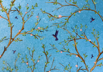 Nature wall mural with apple tree branches and birds on the blue sky