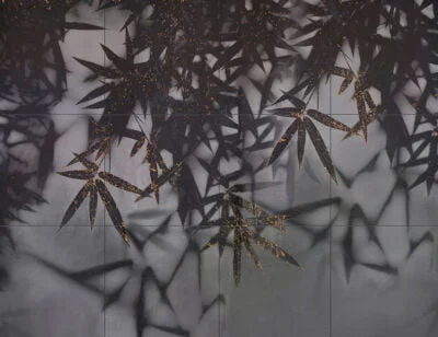 Dark palm leaves wall mural with a touch of gold on a tile