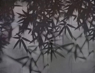 Dark palm leaves on a tile wall mural