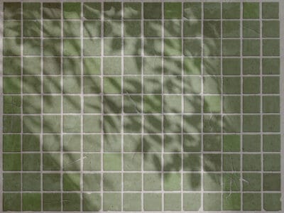 Green stone tiles with leaf shadows wall mural